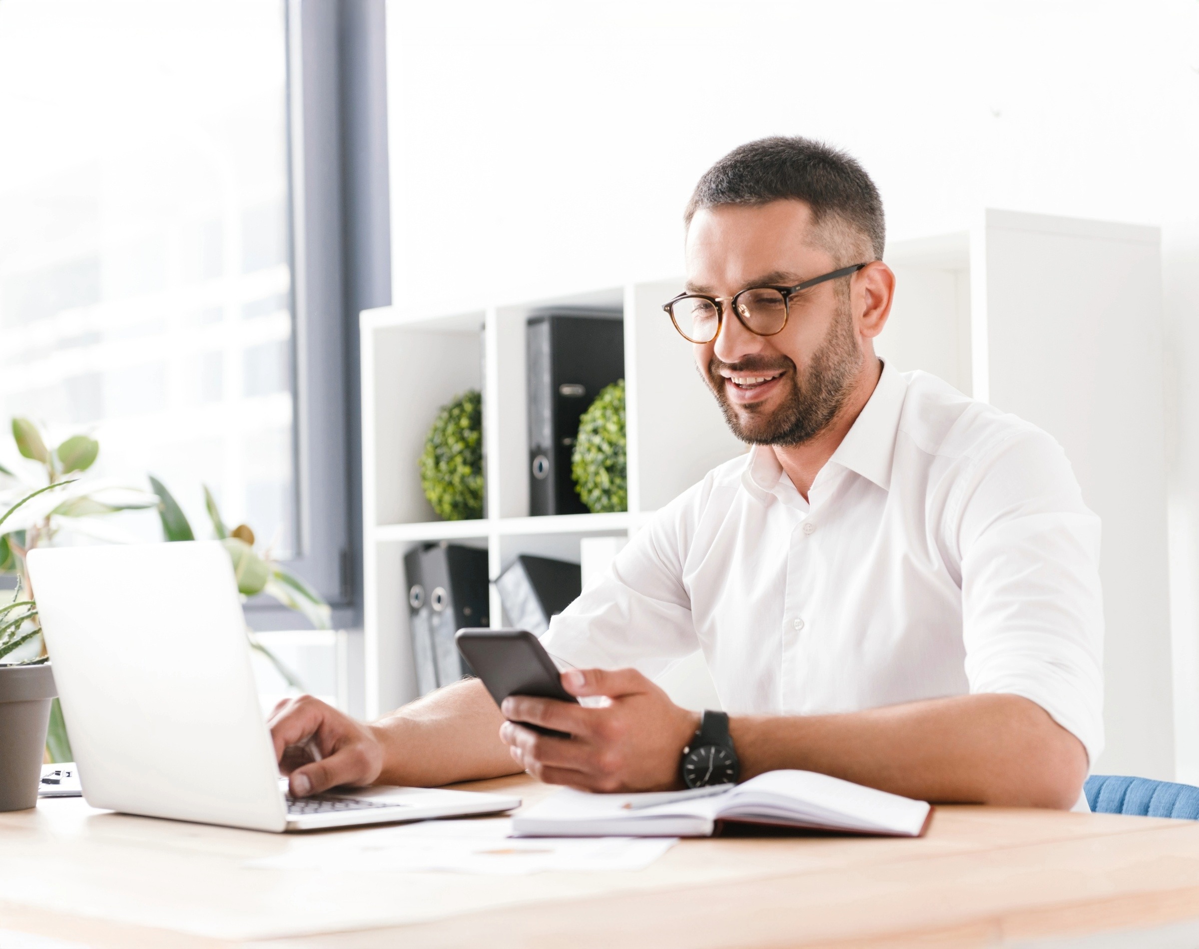 property manager and letting agent using laptop and phone in office
